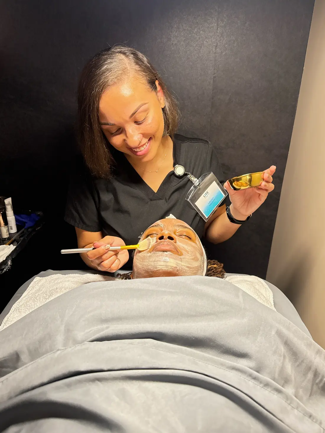 Provider applying a facial mask to a client at LIVE Hydration Spa Cary